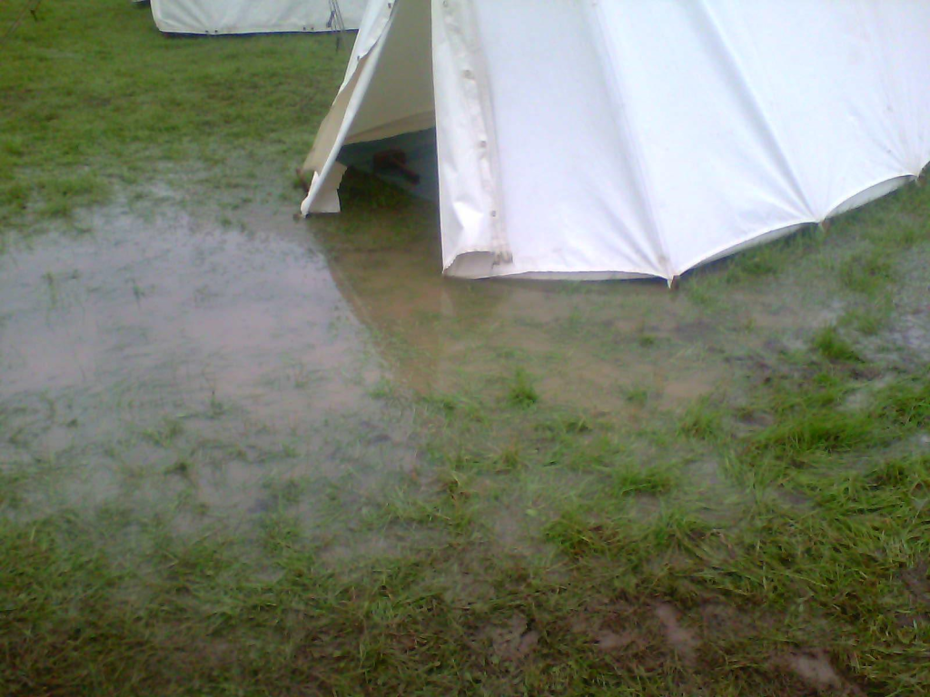 Tent next to a puddle - A very wet morning at a reenactment event. 